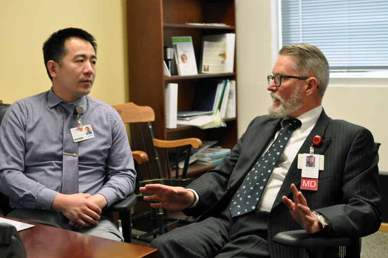 Dr. Qiao and Dr. McCune discuss their research on using AI for scientific articles.JPG