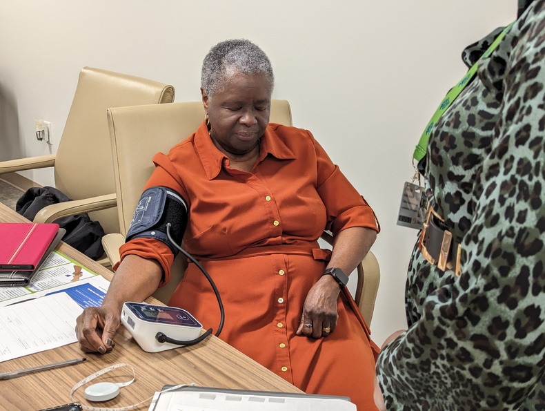 Pastor Sharon S. Riley checks blood pressure as part of Sentara study.jpg