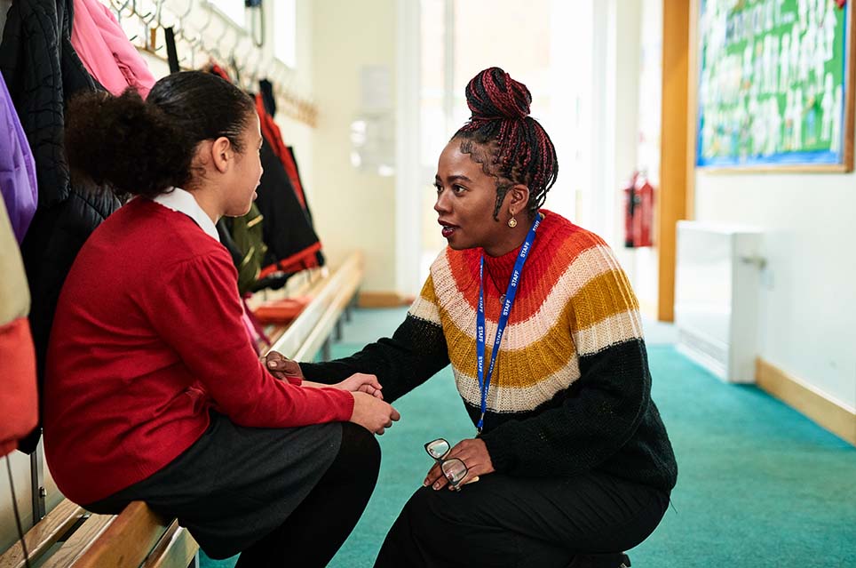 adult speaking with student