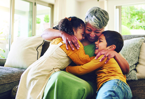 mature woman hugging two children