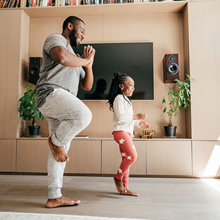 father and daughter doing yoga together