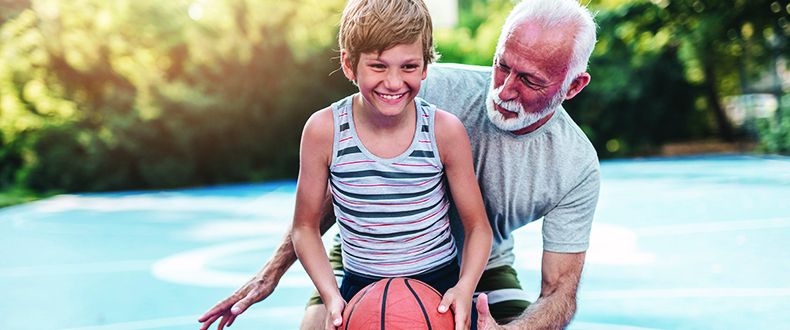 young-boy-playing-basketball-with-older-man